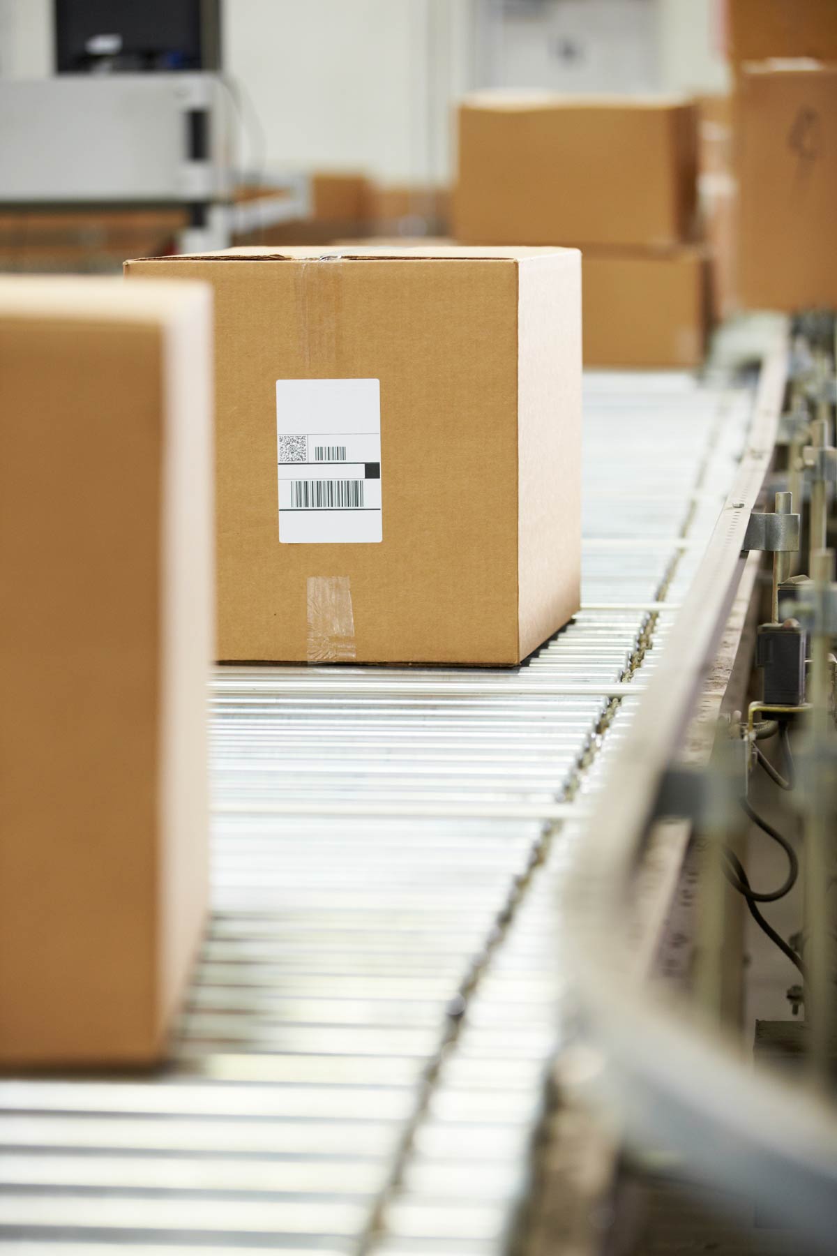 Shipping boxed orders down a conveyor belt to be delivered to consumers.