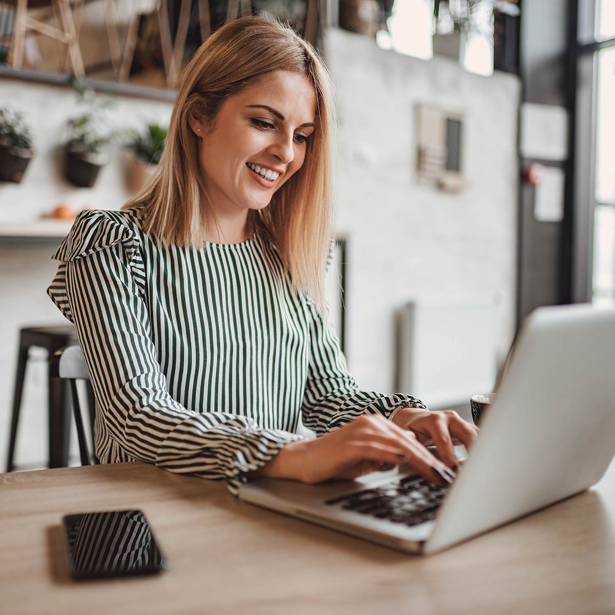 Woman uses web chat on her computer for presales questions about a home product.